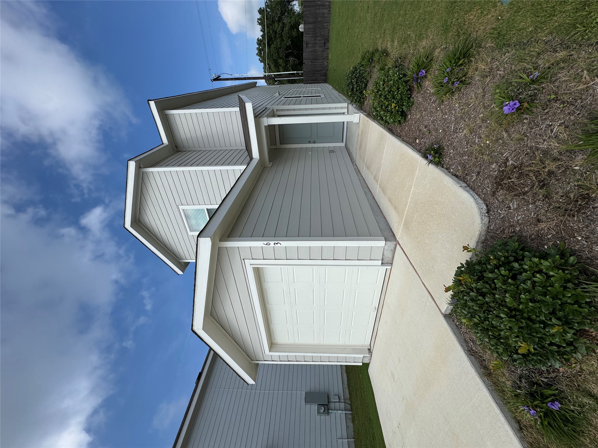Super cute home with a fresh exterior, tidy landscaping, easy to maintain lawn with a one car attached garage