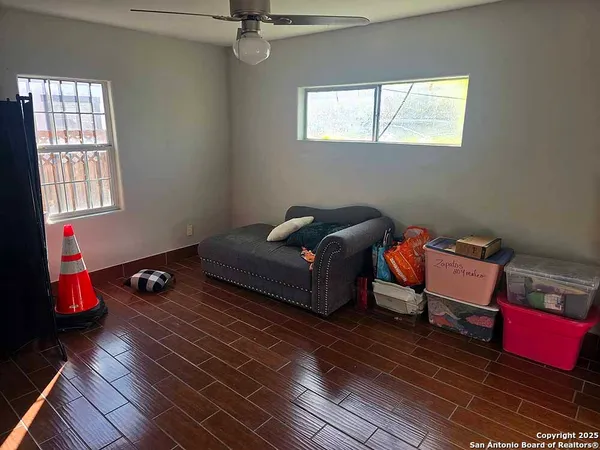 an empty room with wooden floor and mirror