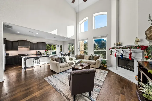 a living room with fireplace furniture and a wooden floor
