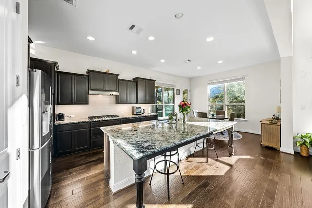 a kitchen with stainless steel appliances granite countertop a stove and refrigerator
