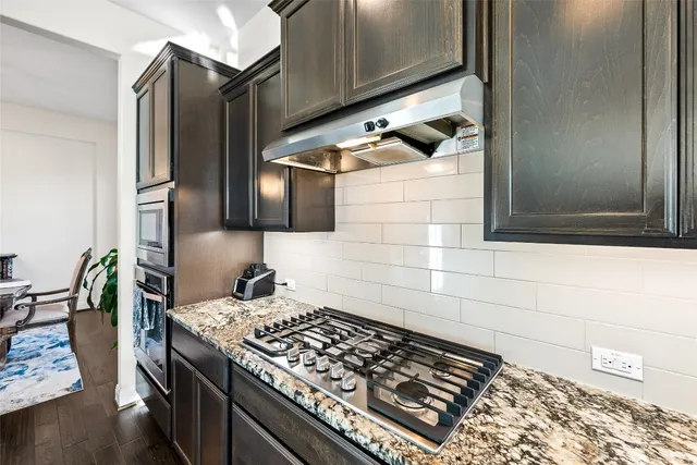 a kitchen with a stove and a shower