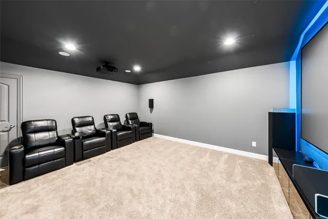 a living room with furniture a flat screen tv and kitchen view