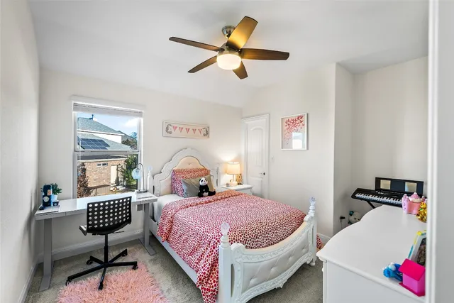 a bedroom with a bed a couch and a window