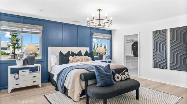 a bedroom with furniture and wooden floor