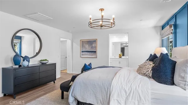 a bedroom with a bed and a chandelier