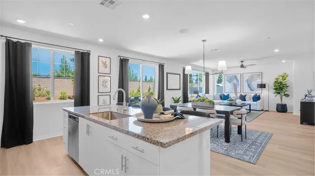 a kitchen with granite countertop a counter top space and living room