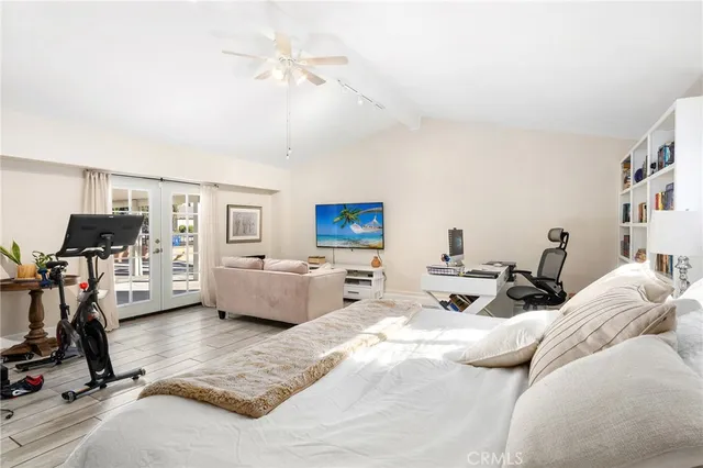 a bedroom with furniture a ceiling fan and a window