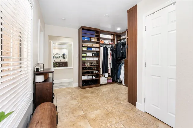 a view of a patio with a table chairs and a floor to ceiling window