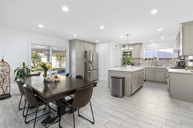 a kitchen with a table chairs and a refrigerator