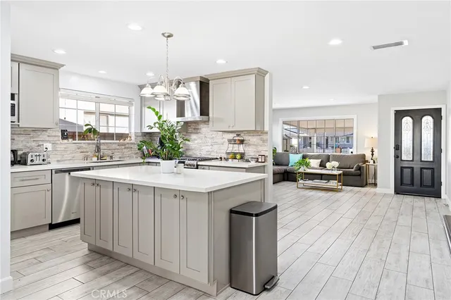 a kitchen with sink stove and cabinets