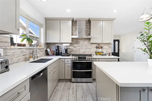 a kitchen with a sink stove and cabinets