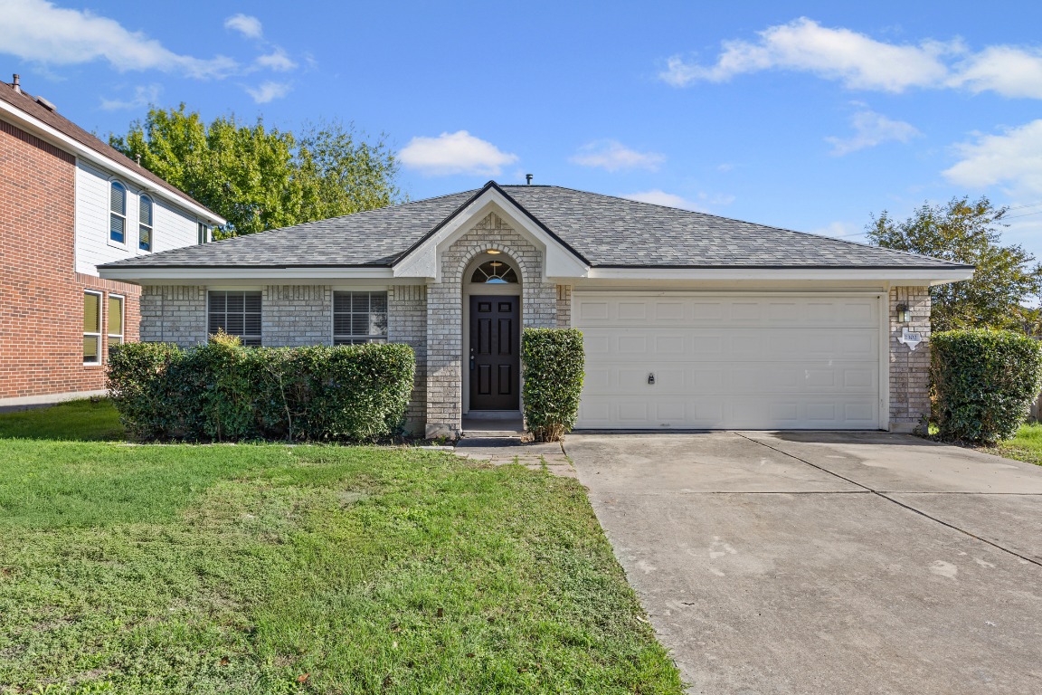 2302 Loquat Lane Round Rock, TX 78664 - Photo 1 of 1 a front view of a house with a garden and yard