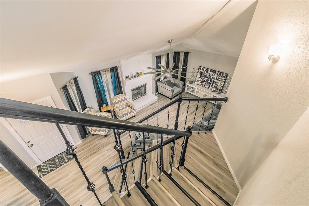 3025 David Drive Rowlett, TX 75088 - Photo 12 of 23 Stairs with wood finished floors and lofted ceiling