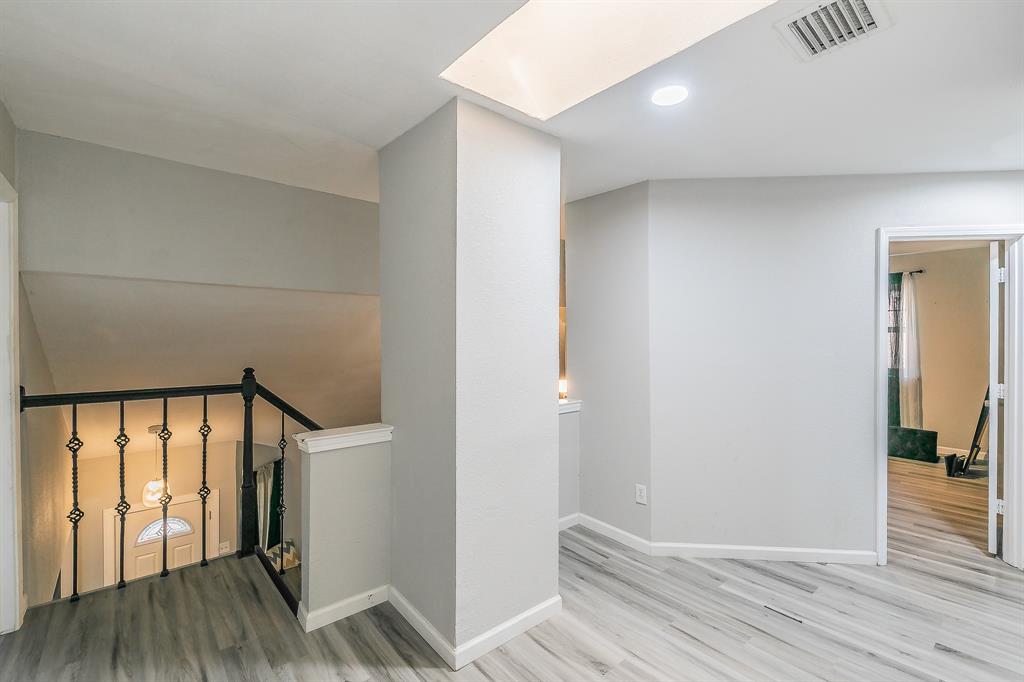 3025 David Drive Rowlett, TX 75088 - Photo 13 of 23 Staircase with wood finished floors and a skylight