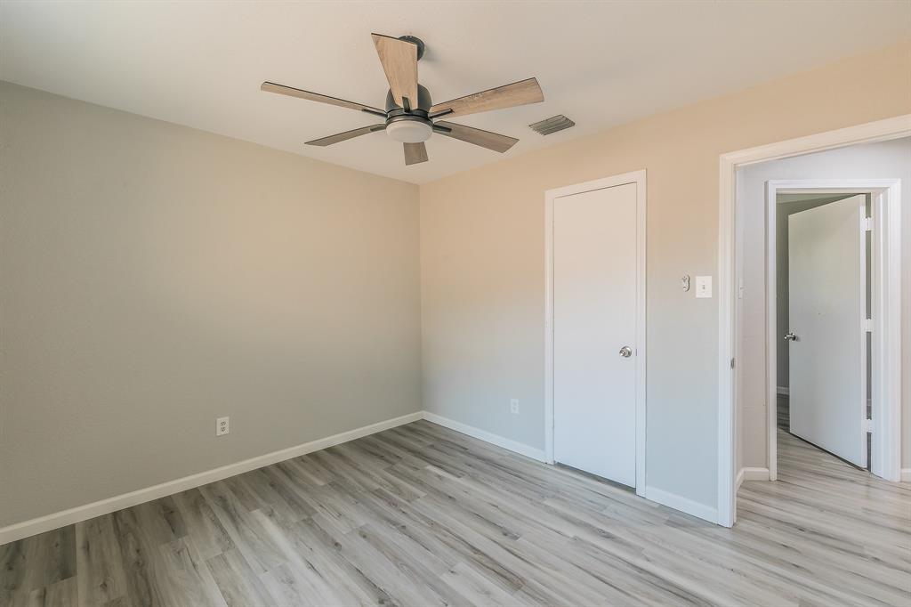3025 David Drive Rowlett, TX 75088 - Photo 18 of 23 Unfurnished bedroom with light wood finished floors and ceiling fan