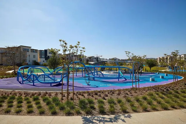a sign board with a play ground in the back