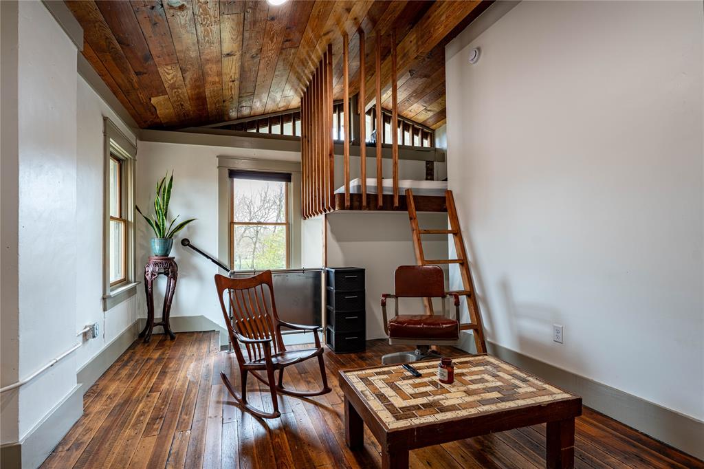 621 South Main Street Paris, TX 75460 - Photo 26 of 30 Living area featuring baseboards, wood ceiling, lofted ceiling, and wood-type flooring
