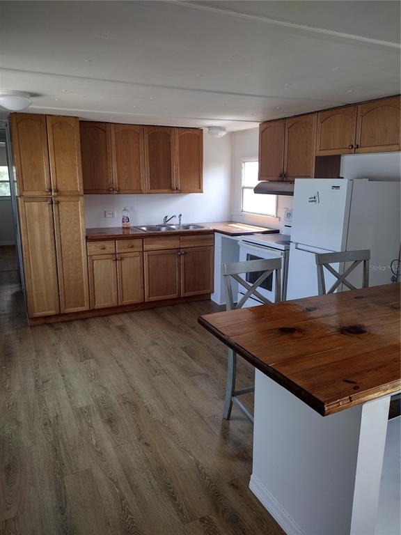 123 Alice Street Edgewater, FL 32141 - Photo 3 of 4 a kitchen with a sink cabinets and wooden floor