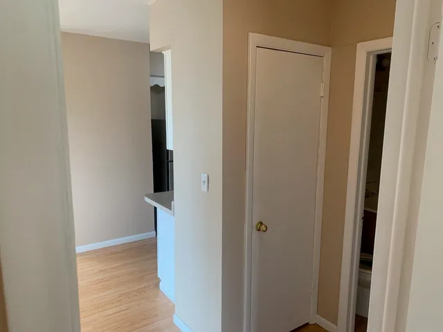 a view of hallway with wooden floor