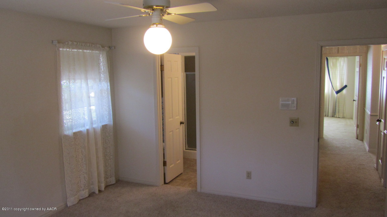 6708 Jameson Road Amarillo, TX 79106 - Photo 8 of 19 a view of a hallway with wooden floor