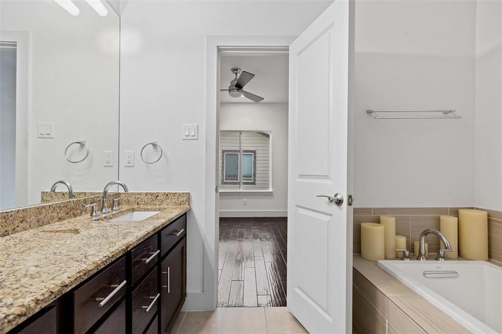 5924 Hudson Street, Unit F Dallas, TX 75206 - Photo 20 of 25 a en suite bathroom with a granite countertop sink and a mirror