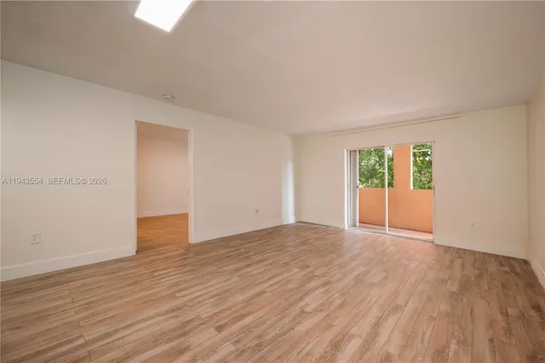 a walk in closet with white walls