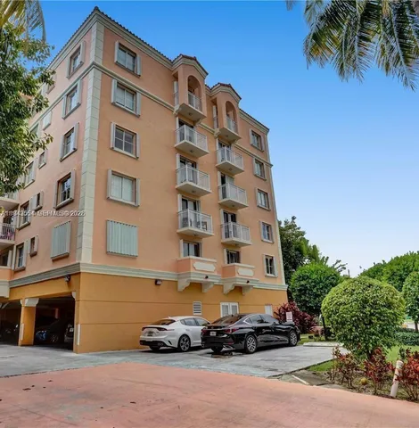 a view of a swimming pool with potted plants and big trees