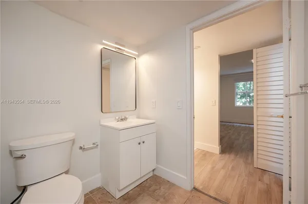 a bathroom with a toilet sink and shower