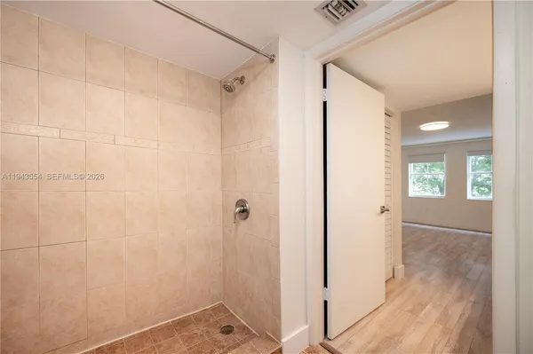 a view of walk in closet with empty racks