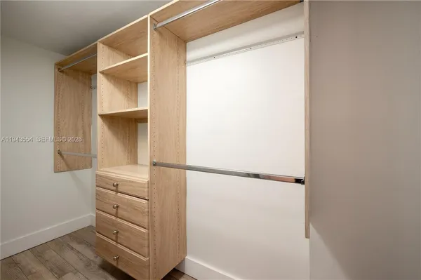 a view of an empty room and wooden floor