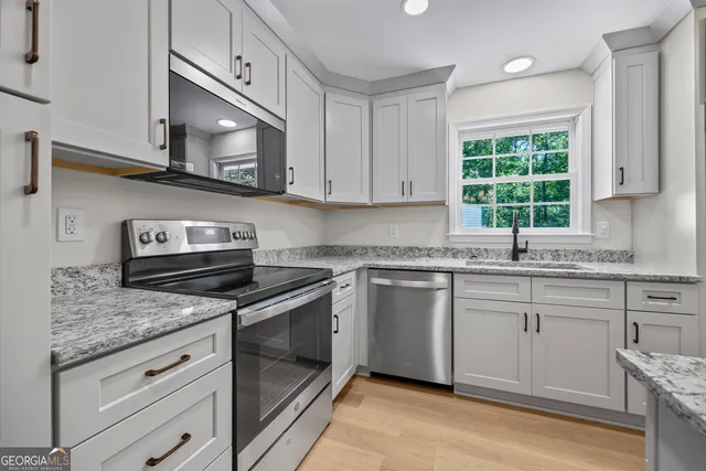 an empty room with wooden floor and window