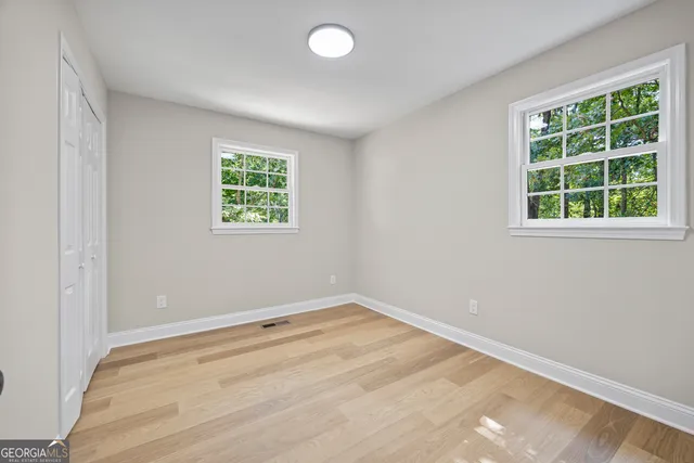 a view of an empty room and wooden floor