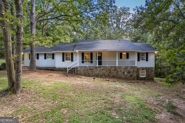 a bathroom with a granite countertop sink a toilet and a mirror