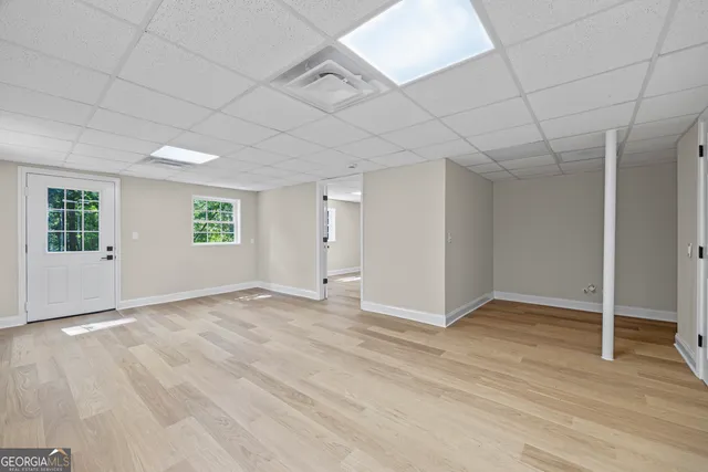 a view of an empty room with wooden floor