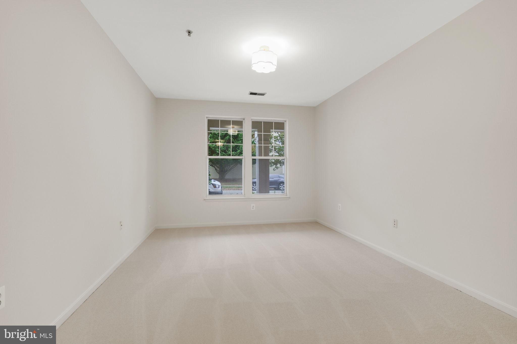 150 Chevy Chase Street, Unit 102 Gaithersburg, MD 20878 - Photo 13 of 41 an empty room with a window