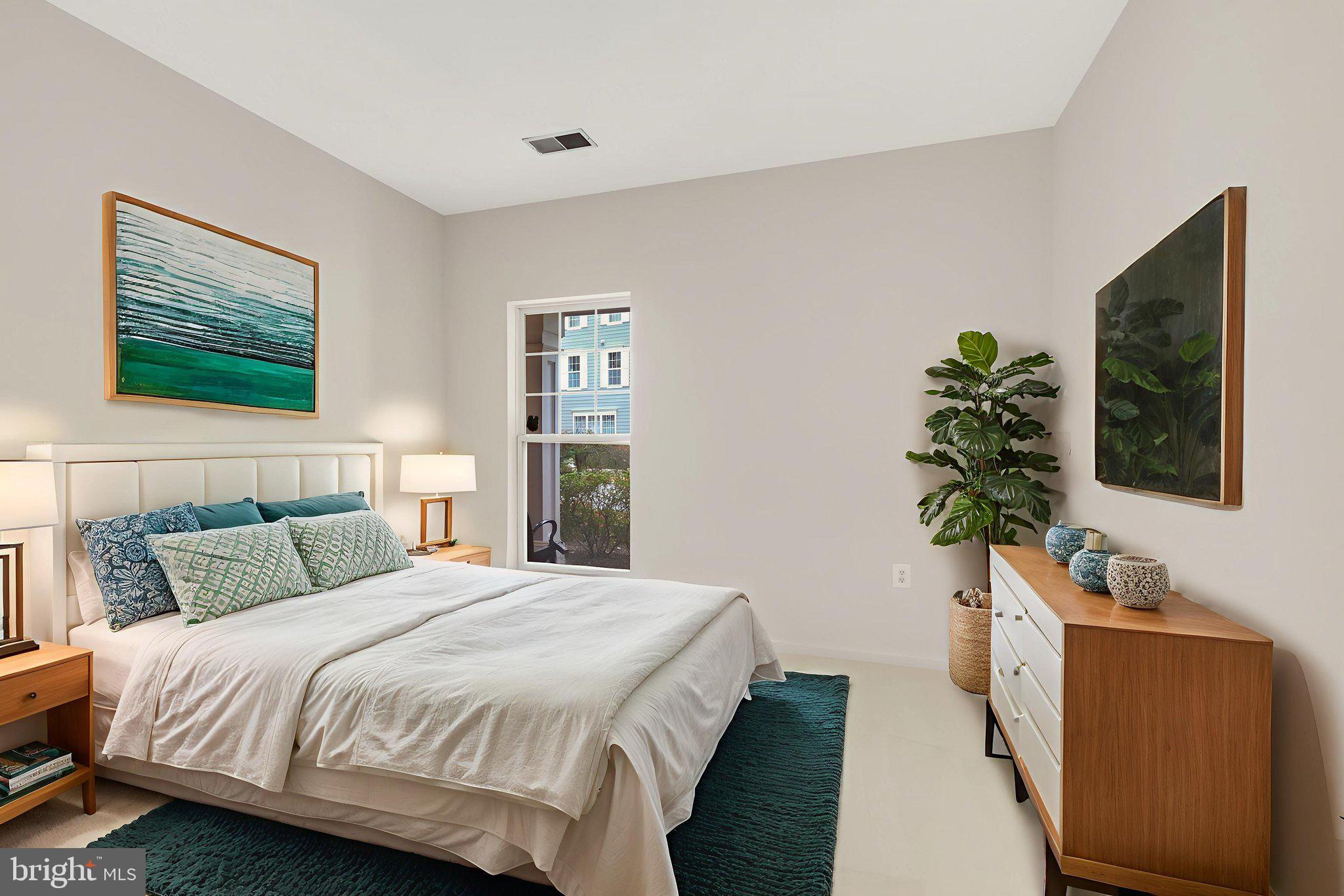 150 Chevy Chase Street, Unit 102 Gaithersburg, MD 20878 - Photo 18 of 41 a bedroom with bed and a flat screen tv