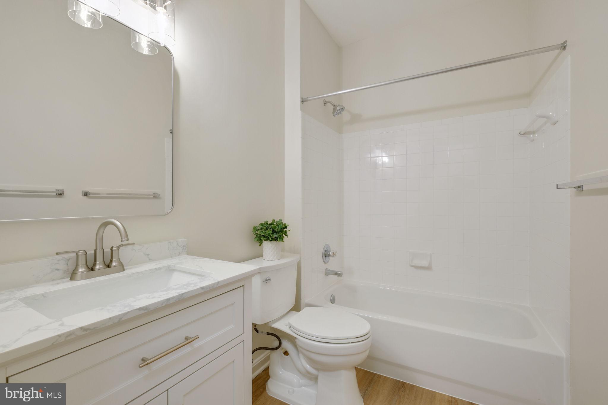 150 Chevy Chase Street, Unit 102 Gaithersburg, MD 20878 - Photo 21 of 41 a bathroom with a sink a toilet and shower