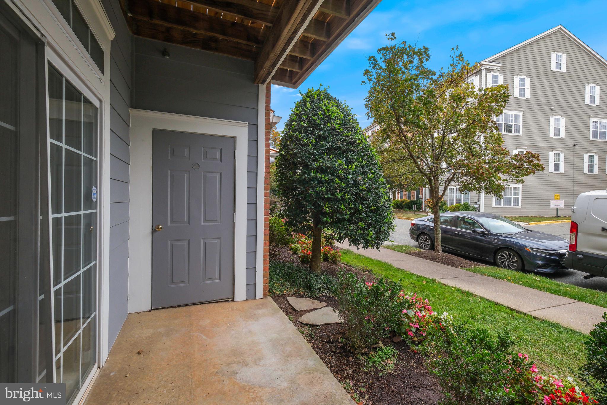 150 Chevy Chase Street, Unit 102 Gaithersburg, MD 20878 - Photo 23 of 41 a view of a house with a yard and potted plants
