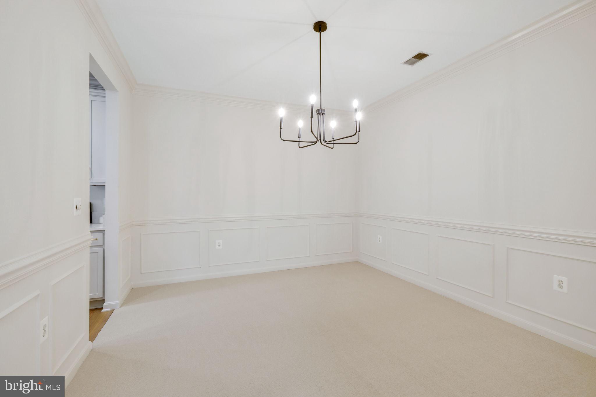 150 Chevy Chase Street, Unit 102 Gaithersburg, MD 20878 - Photo 9 of 41 a view of a room with a hanging light and kitchen view