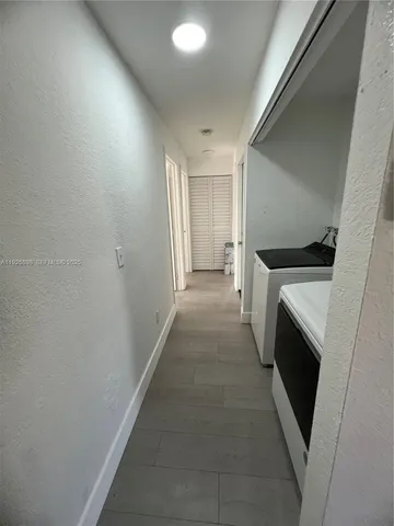 a hallway with washer and dryer