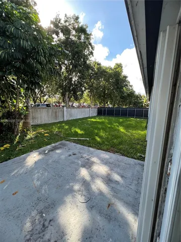 a view of a yard with large trees