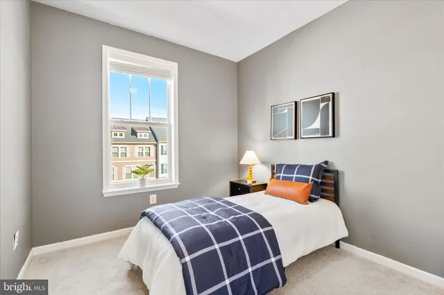 a bedroom with a bed and painting on the wall