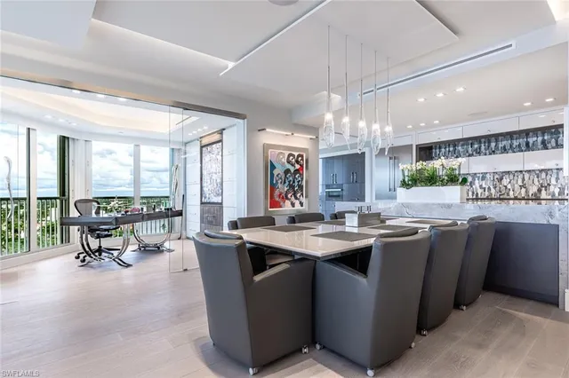a kitchen with stainless steel appliances a table and chairs