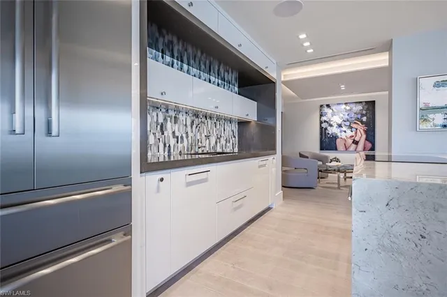 a kitchen with stainless steel appliances granite countertop lots of counter top space and wooden floor