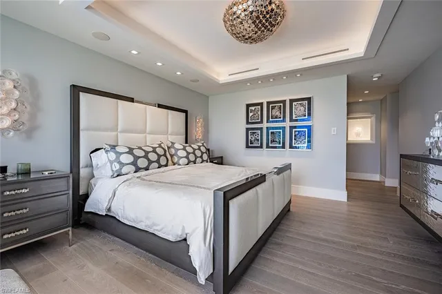 a bathroom with a granite countertop double vanity sink a mirror and a bathtub