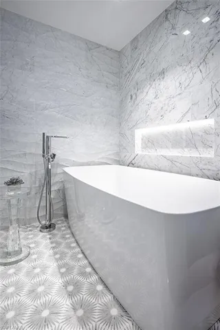 a bathroom with a bathtub and shower