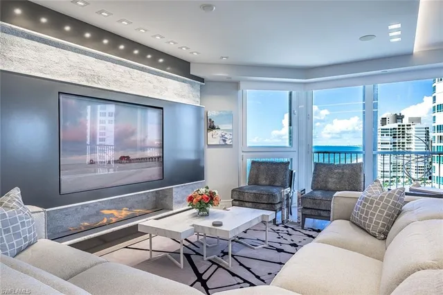 a living room with furniture and a large window