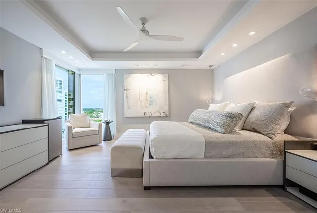 a bedroom with a large bed dresser and window