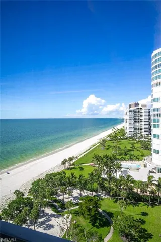 a view of a house with swimming pool and sitting area
