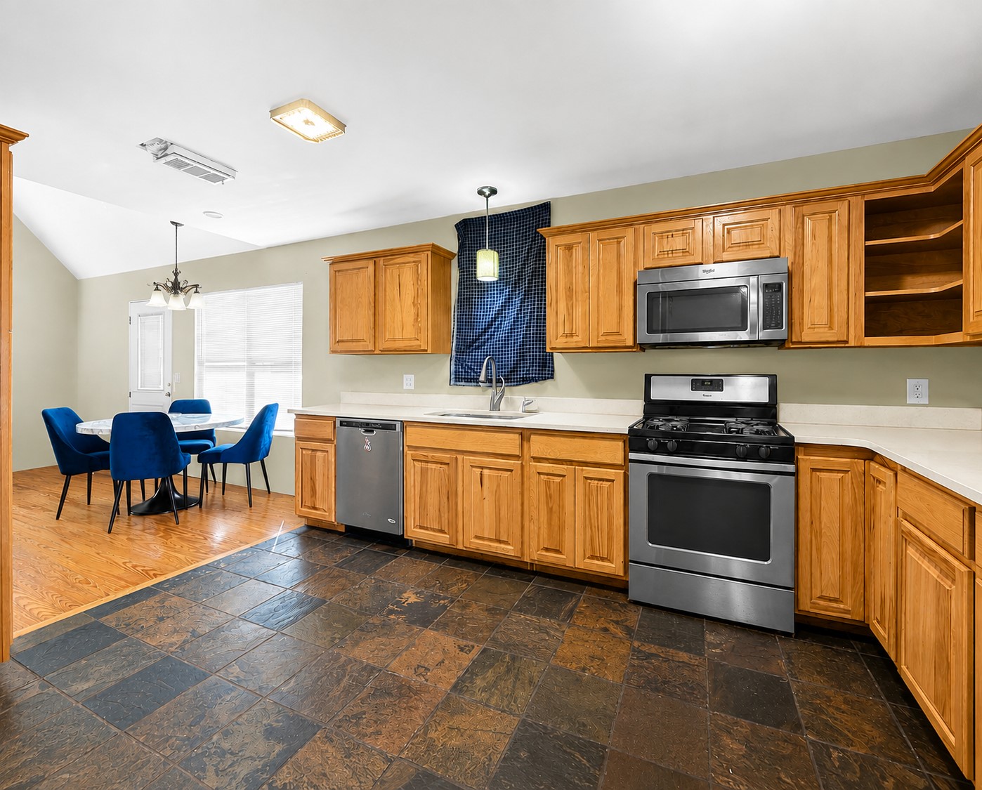925 Long Hollow Road Dale, TX 78616 - Photo 6 of 21 Warm oak cabinetry pairs with durable stone look tile flooring in this functional kitchen.